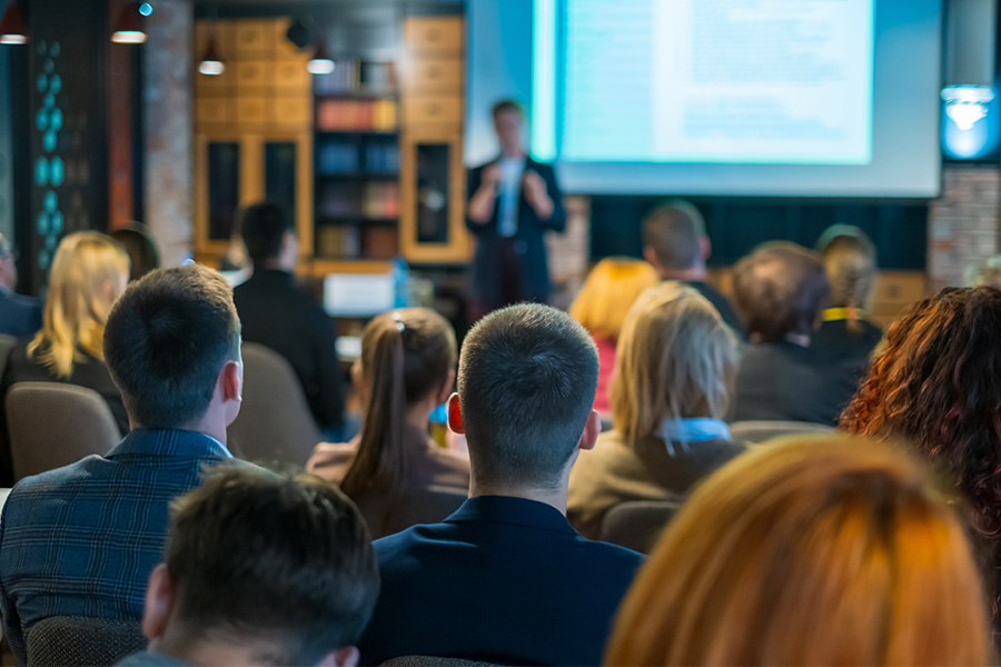 mixed group of business professionals listening to an instructor